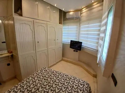 a room with a bed and a window and a tv at Superbe appartement corniche in Casablanca