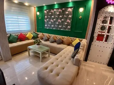 a living room with a couch and a table at Superbe appartement corniche in Casablanca