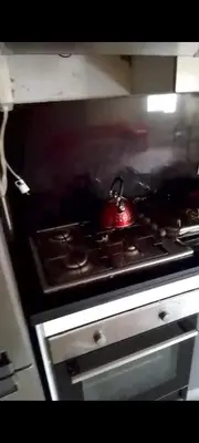 a stove top with a red item on top of it at Mansbay in O Ben Slimane