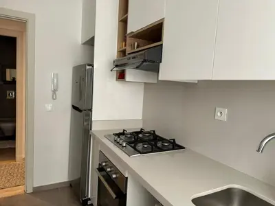 a kitchen with a stove top oven next to a sink at Appartement moderne à Bourgogne 2 chambre in Casablanca-Port