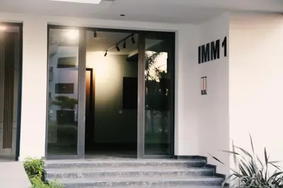an entrance to a white building with glass doors at Studio haut standing CASA in Aïn Harrouda