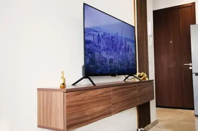 a flat screen tv sitting on top of a wooden entertainment center at Studio haut standing CASA in Aïn Harrouda