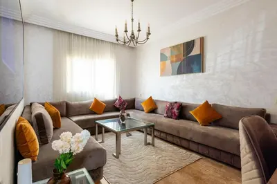 a living room with a couch and a table at Ocean Apartment in Rabat