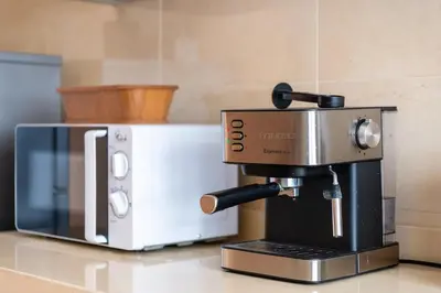 a coffee maker sitting next to a microwave on a counter at Ocean Apartment in Rabat
