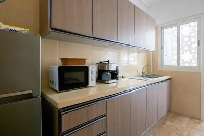 a kitchen with a microwave oven and a sink at Ocean Apartment in Rabat