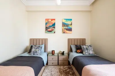 two beds sitting next to each other in a room at Ocean Apartment in Rabat