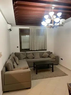 a living room with a couch and a chandelier at Chic Studio in Agdal Walk to Everything in Rabat