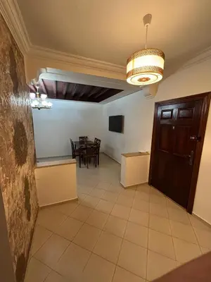 a large room with a dining room with a table at Chic Studio in Agdal Walk to Everything in Rabat