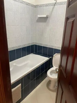 a bathroom with a bath tub and a toilet at Chic Studio in Agdal Walk to Everything in Rabat