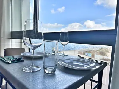 a table with two wine glasses and plates on it at Marina Lifestyle ! in Casablanca