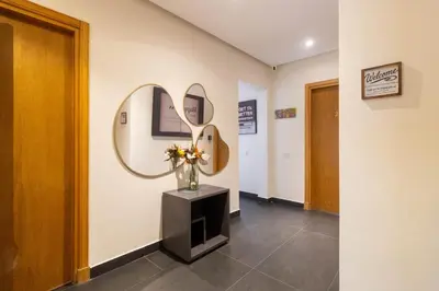 a hallway with a vase of flowers and a mirror at Marina Lifestyle ! in Casablanca