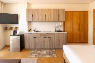 a kitchen with wooden cabinets and a refrigerator at Marina Lifestyle ! in Casablanca