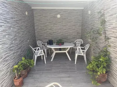 a patio with a table and chairs and plants at Charmante Maison Traditionnelle au Cœur de la Médina, 5 min de Casa Port in Casablanca