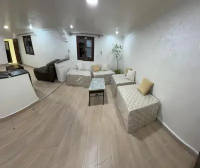 a large living room with a couch and a table at Charmante Maison Traditionnelle au Cœur de la Médina, 5 min de Casa Port in Casablanca