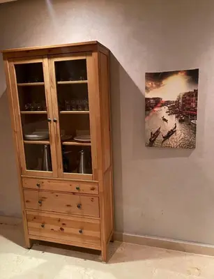 a wooden cabinet in the corner of a room at Prestigia golf city bouskoura in Casablanca