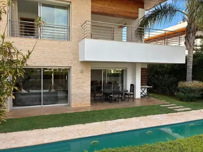 a house with a patio and a swimming pool at Villa Bouznika Bay by Saloua in Bouznika