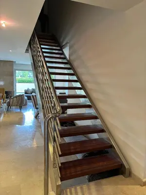 a spiral staircase in a house with a living room at Villa Bouznika Bay by Saloua in Bouznika