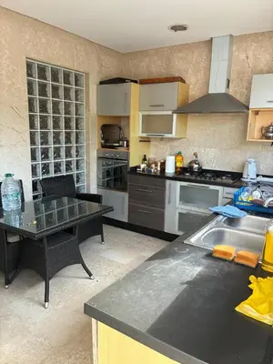 a kitchen with a table and a counter top at Villa Bouznika Bay by Saloua in Bouznika
