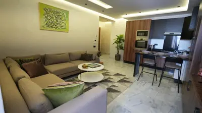a living room with a couch and a table at Escapade Chic Gare - Oasis in Casablanca