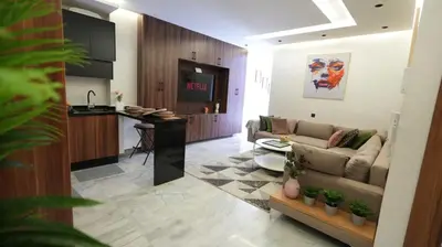 a living room with a couch and a kitchen at Escapade Chic Gare - Oasis in Casablanca