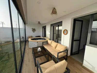 a living room with a couch and a fireplace at Bain de soleil à Dar Bouazza in Dar Bouazza