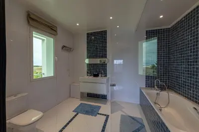 a bathroom with a tub and a toilet and a sink at Asmae House in Skhirat