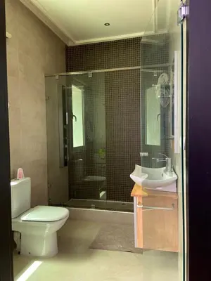 a bathroom with a toilet and a sink and a shower at Asmae House in Skhirat