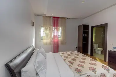 a bedroom with a bed and a window at Asmae House in Skhirat