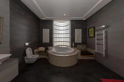 a large bathroom with a tub and a toilet at Asmae House in Skhirat