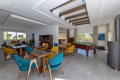 a dining room with tables and a pool table at Asmae House in Skhirat