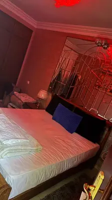 a bedroom with a bed with a red wall at Diar 4 in Casablanca