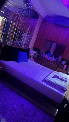 a bedroom with a large bed with purple lighting at Diar 4 in Casablanca