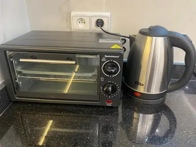 a toaster oven with a coffee pot on a counter at Chic city center studio in Casablanca