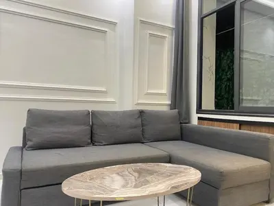 a living room with a gray couch and a coffee table at Chic city center studio in Casablanca