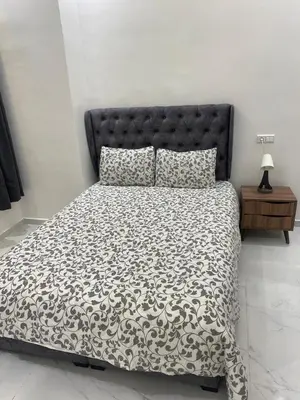 a bedroom with a bed with a black and white comforter at Chic city center studio in Casablanca