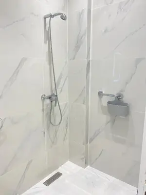 a shower with a glass door in a bathroom at Chic city center studio in Casablanca