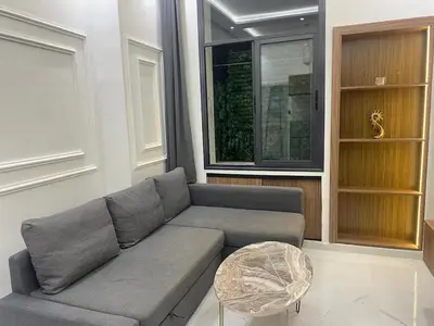 a living room with a gray couch and a table at Chic city center studio in Casablanca