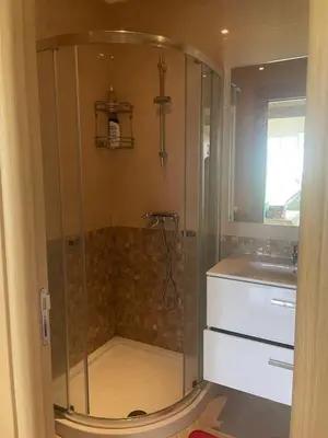 a glass shower in a bathroom with a sink at Casabay Sidi Rahal, à 2mn de la mer en bord de piscine et jardin in Sidi Rahal