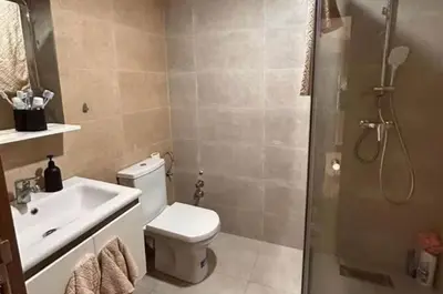 a bathroom with a toilet and a sink and a shower at résidence à louer in Nouaceur