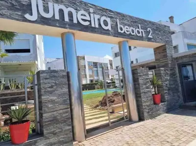 a sign for a jumeirah beach hotel at Appartement de plage front de mer in Tamaris