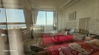 a room with two beds and a window at Appartement de plage front de mer in Tamaris