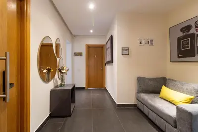 a living room with a couch and a mirror at Studio prestige avec Terrasse sur la Marina in Casablanca