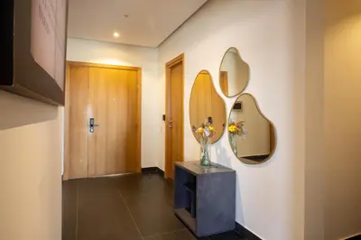a hallway with two mirrors and a vase with flowers at Studio prestige avec Terrasse sur la Marina in Casablanca