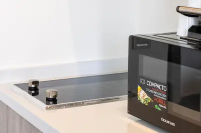 a black microwave oven sitting on top of a counter at Studio prestige avec Terrasse sur la Marina in Casablanca