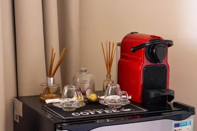 a table with a coffee maker and glasses on it at Studio prestige avec Terrasse sur la Marina in Casablanca