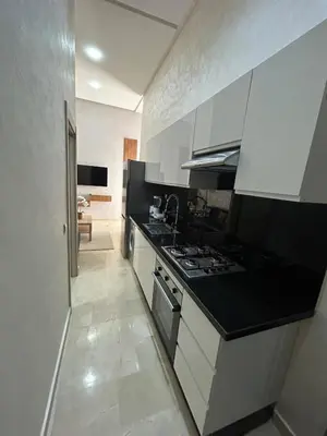 a kitchen with white cabinets and a stove top oven at Casa Chic Studio Apartment in Casablanca