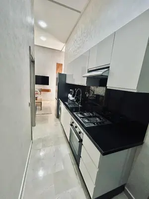 a kitchen with white cabinets and a stove top oven at Casa Chic Studio Apartment in Casablanca