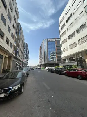 a street with cars parked on the side of the road at Casa Chic Studio Apartment in Casablanca