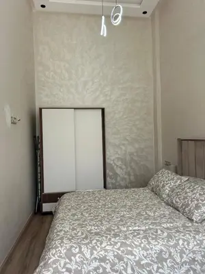 a bedroom with a bed and a white wall at Casa Chic Studio Apartment in Casablanca