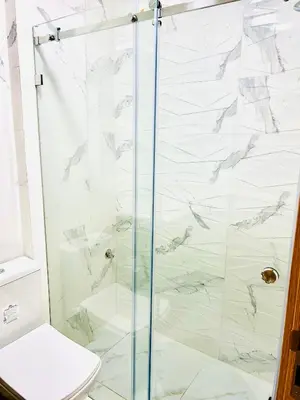 a bathroom with a glass shower with a toilet at Casa Chic Studio Apartment in Casablanca